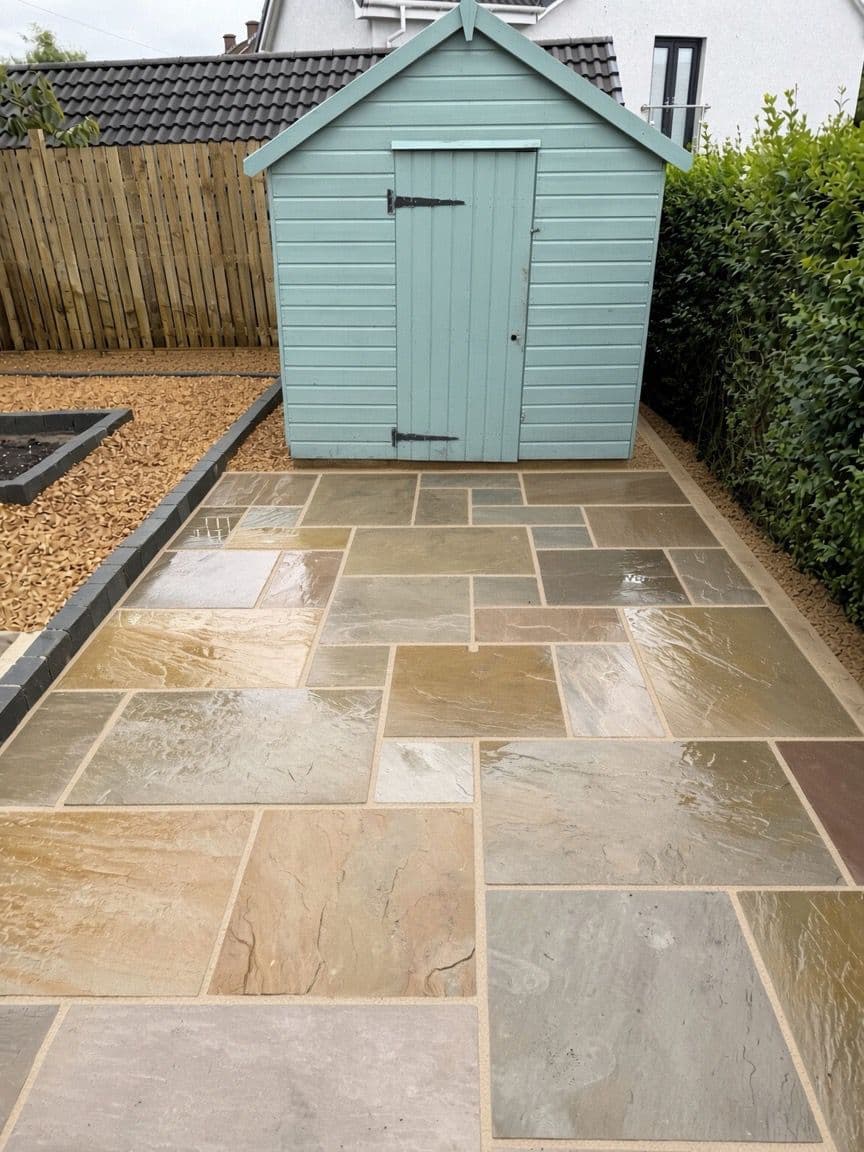 Improved rear garden with a new sandstone patio leading to a repainted garden shed
