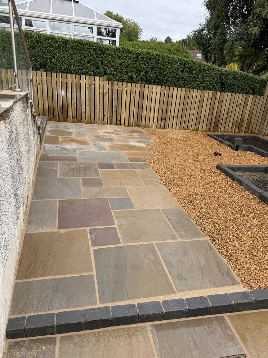 Close-up of multi-tone sandstone patio paving at a property in Clydebank