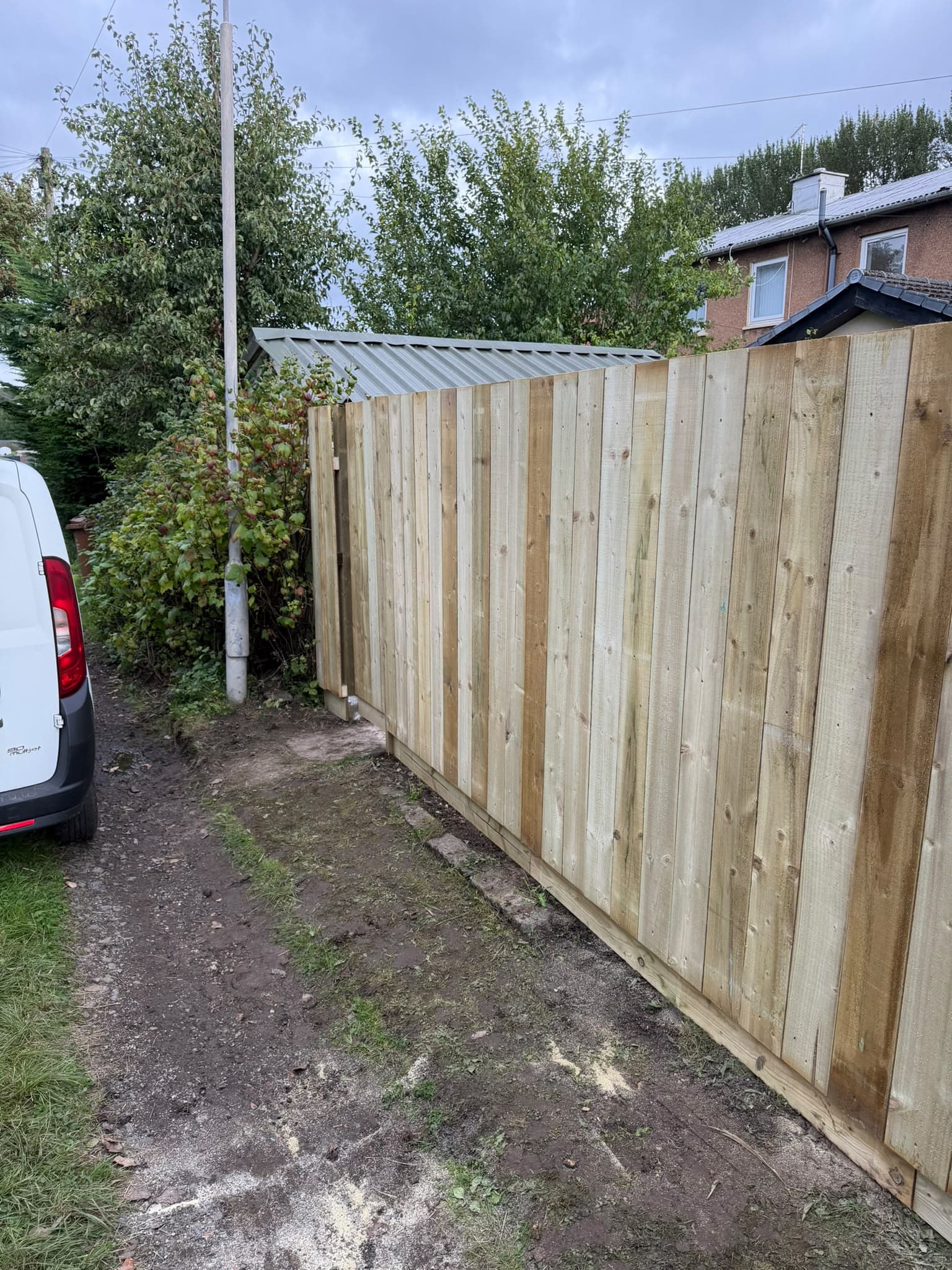 New pressure-treated close-board boundary fence finished along a rear service lane in Auldhouse, Glasgow
