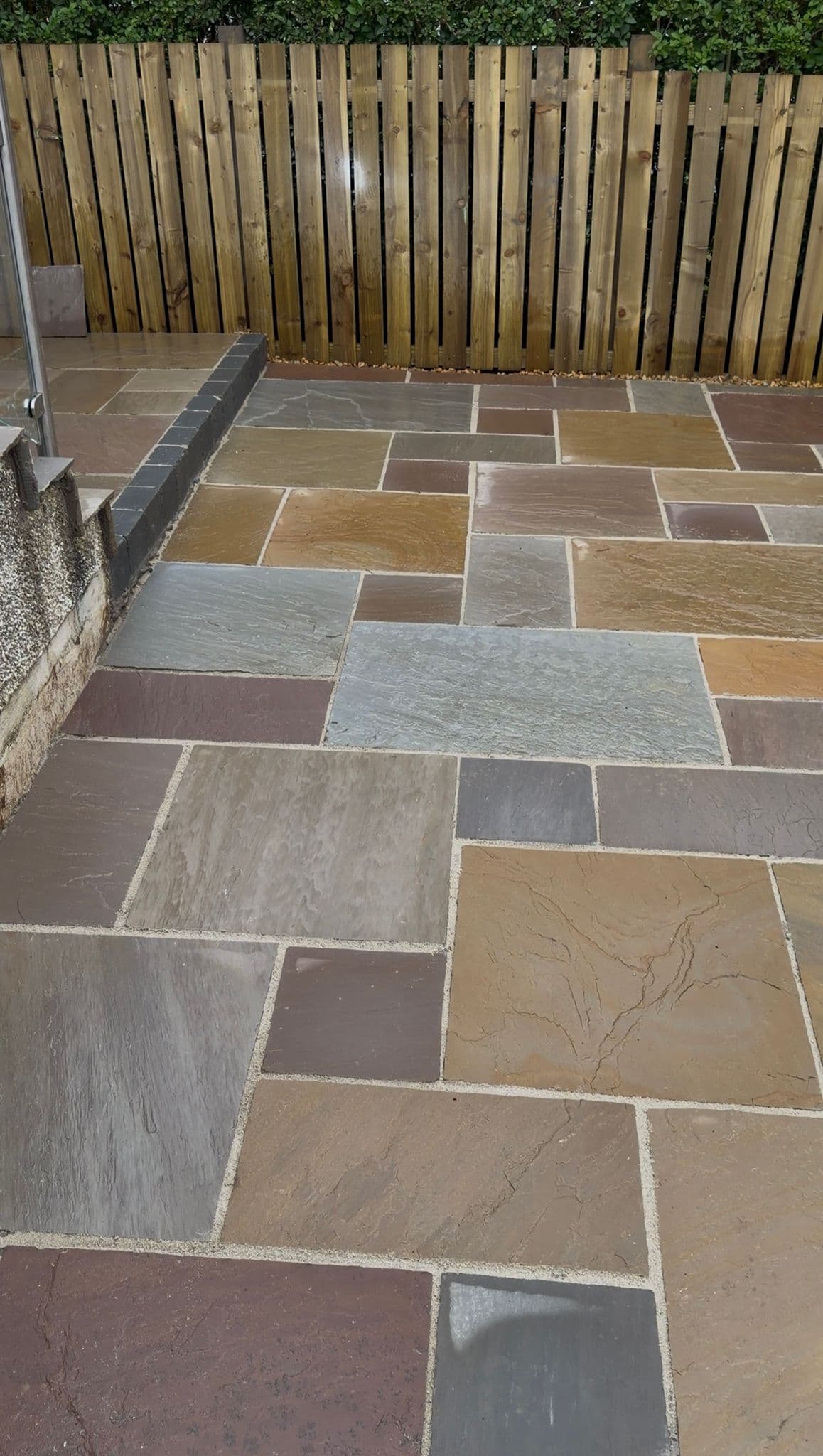 Sandstone patio steps with a glass balustrade at a Bridge of Weir property