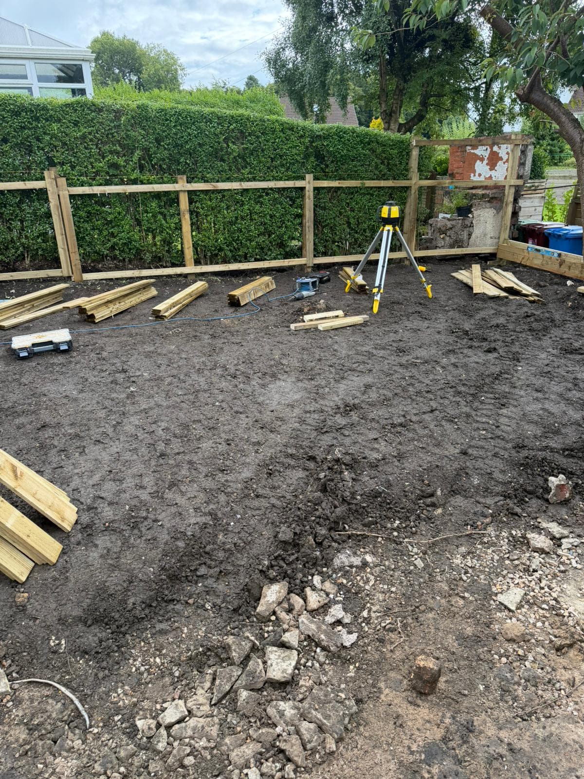 Groundworks in a rear garden with soil being reworked before new landscaping goes in